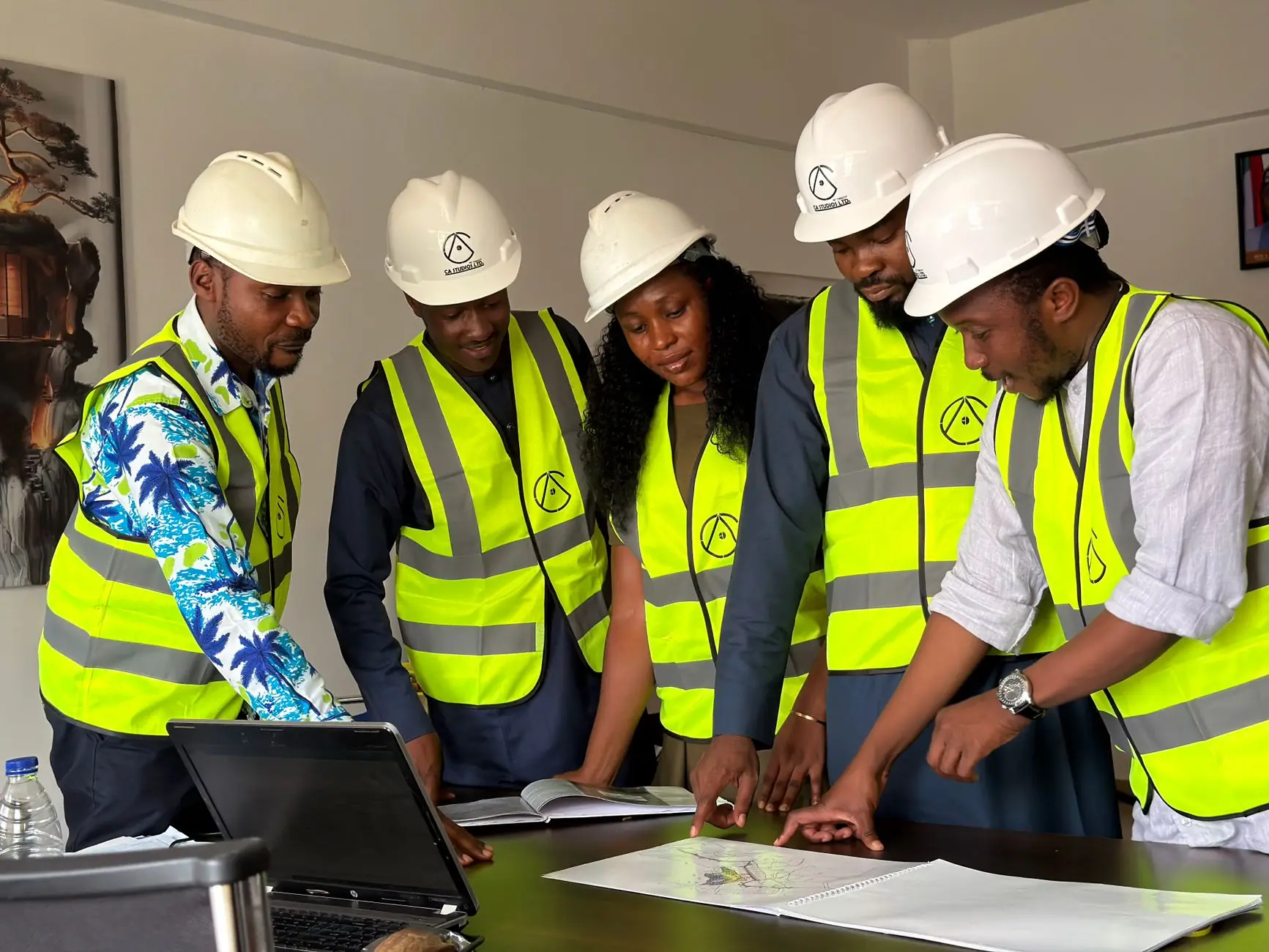 Nigerian engineers planning a project around a table