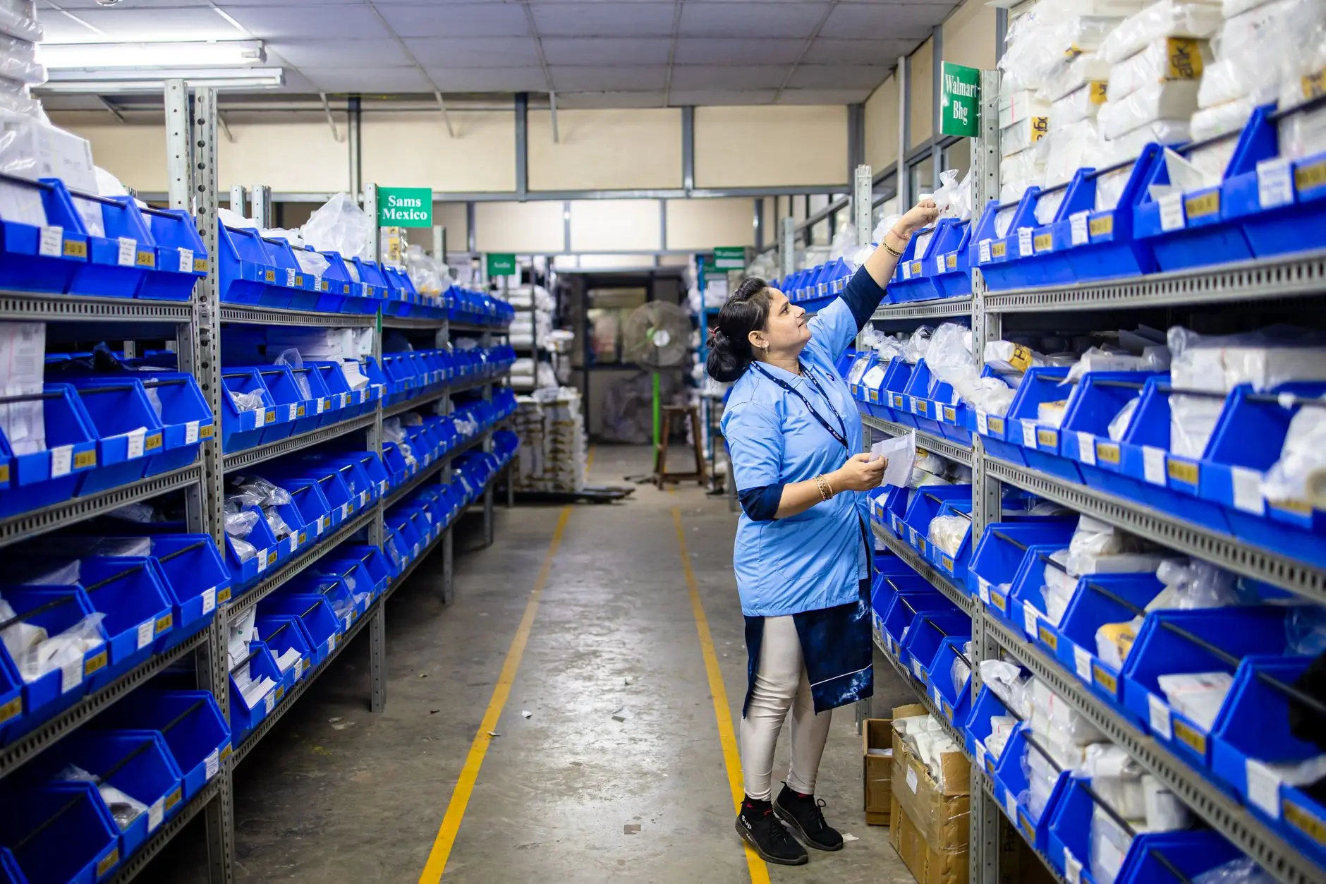 Staff picking supplies from warehouse shelves